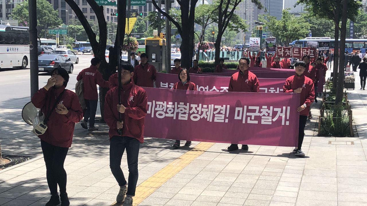 An organization called People's Democracy Party protests after Trump's announcement on Friday. The sign says "Shut up Trump. US forces, leave."