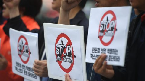 South Korean peace activists hold placards reading "Stop! Max Thunder," during a rally denouncing South Korea-US joint military drills, in front of the US embassy in Seoul on May 16, 2018.