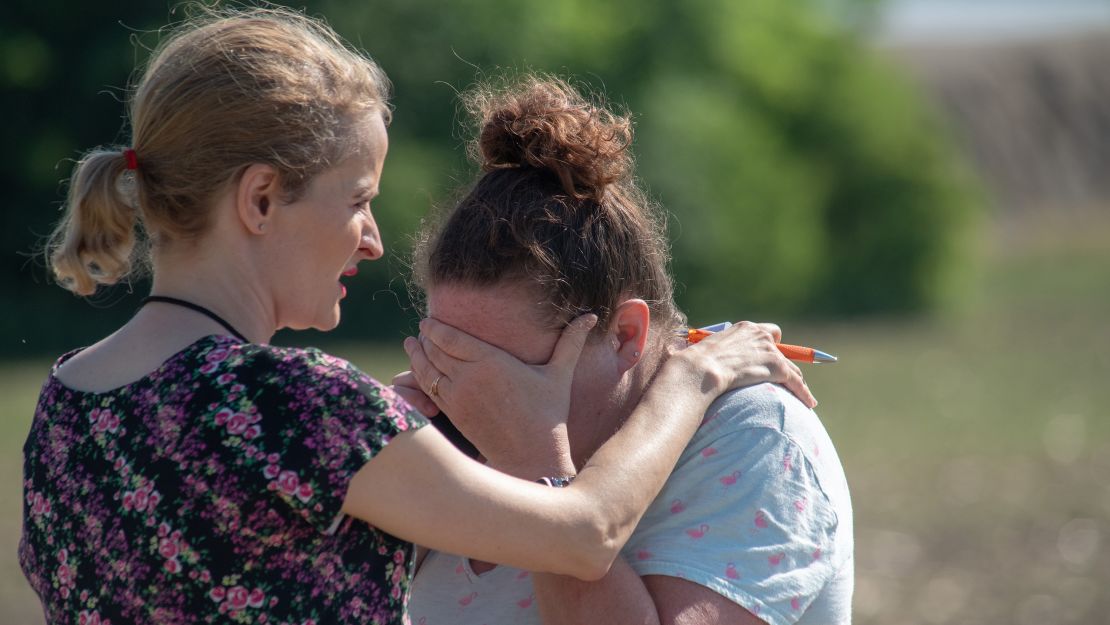 Substitute teacher Joanie Lynne consoles instructional assistant Paige Rose after the shooting.