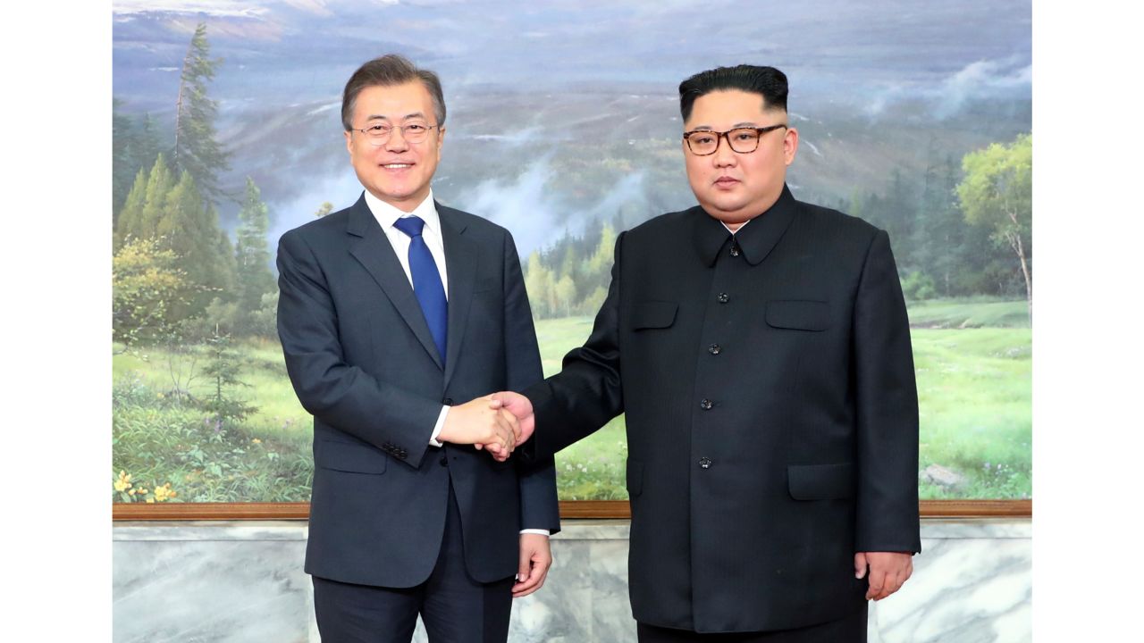 The North and South Korean leaders greet each other before Saturday's meeting.
