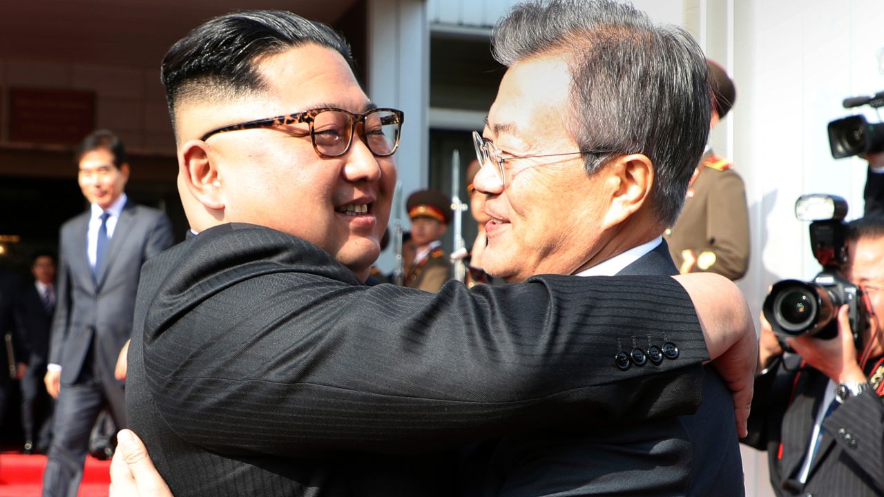 Moon and Kim embrace before their meeting on Saturday. 