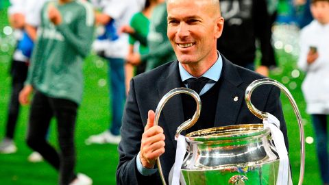 Real Madrid's French coach Zinedine Zidane poses with the trophy after winning  the UEFA Champions League final  against Liverpool.