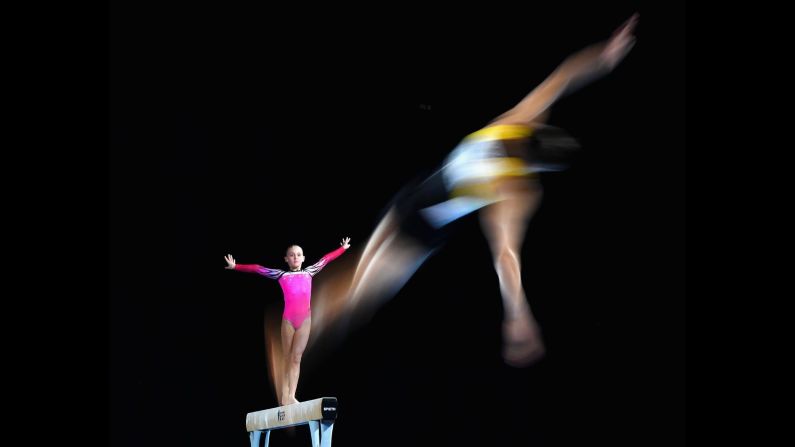 Tyarn Lees of New South Wales competes on the beam as Ryan Inouye of Western Australia competes on the floor during the 2018 Australian Gymnastics Championships at Hisense Arena in Melbourne, Australia, on Tuesday, April 22.