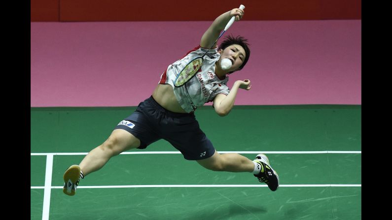 Japan's Akane Yamaguchi hits a return against Thailand's Ratchanok Intanon during the women's singles final match at the Thomas and Uber Cup badminton tournament in Bangkok on Saturday, May 26. 