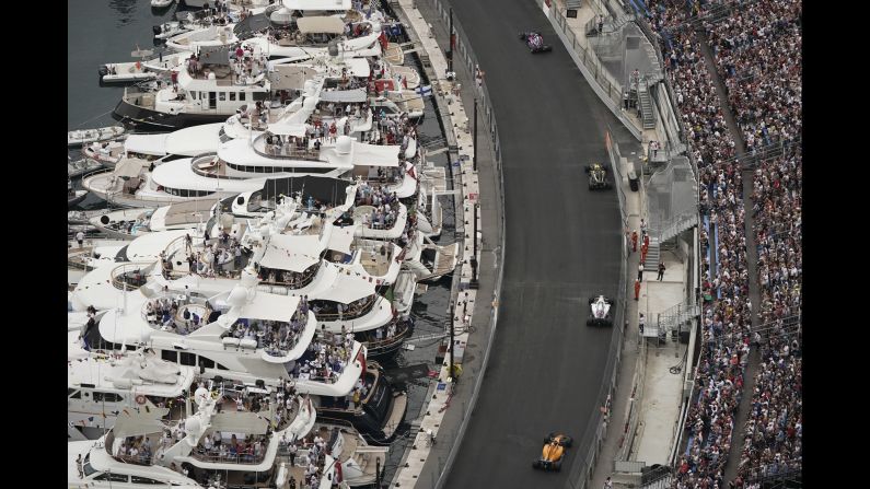 Fans watch from yachts as Formula One drivers speed along the wall during the Monaco Formula One Grand Prix in Monaco, Sunday, May 27.