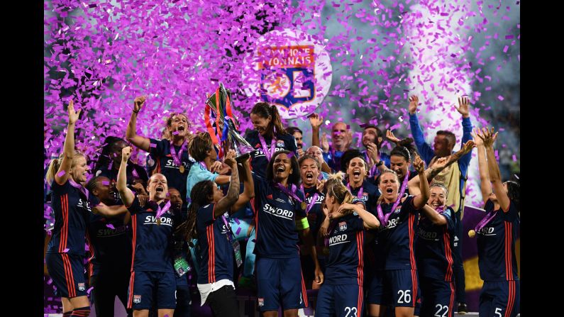 Olympique Lyonnais' French defender Wendie Renard, center, holds the trophy as she and teammates celebrate victory in the UEFA Women's Champions League final football match against Vfl Wolfsburg in Kiev, Ukraine, on Thursday, May 24. Olympique Lyonnais won 4-1, their third trophy in a row. 