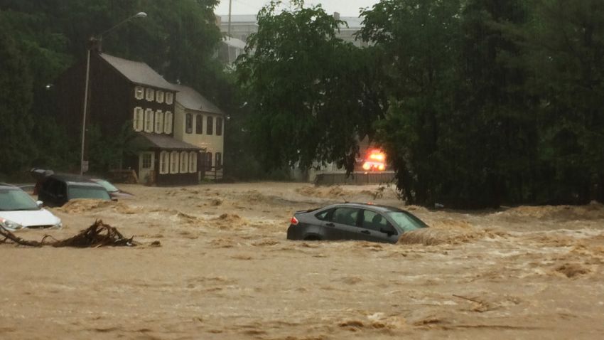 Water rushes through Main Street in Ellicott City, Md., Sunday, May 27, 2018. Flash flooding and water rescues are being reported in Maryland as heavy rain soaks much of the state. (Kenneth K. Lam/The Baltimore Sun via AP)