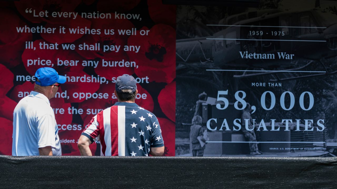 Visitors at the "Poppy Memorial", a temporary memorial made by USAA consisting of more than 645,000 poppy flowers, with each flower honoring each man and woman who gave their life in military service to the US since World War I, at the National Mall on Saturday, May 26, 2018 in Washington. (Rodney Choice/AP Images for USAA)