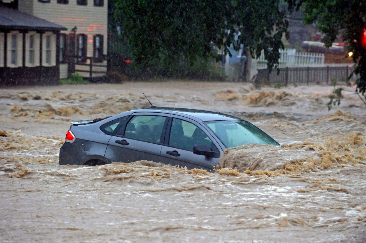 A car is flooded in a lot near Main Street on Sunday.