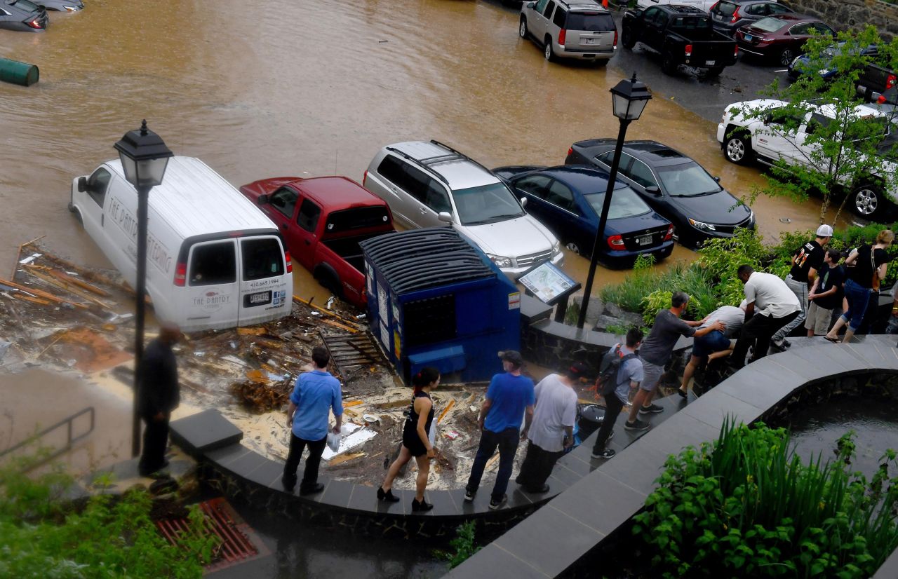 People evacuate the Ellicott Mills Brewing Co. on Sunday. Many businesses had just finished rebuilding from the 2016 flooding, according to Howard County Executive Allan Kittleman. "There are no words," he said. "It's heartbreaking."