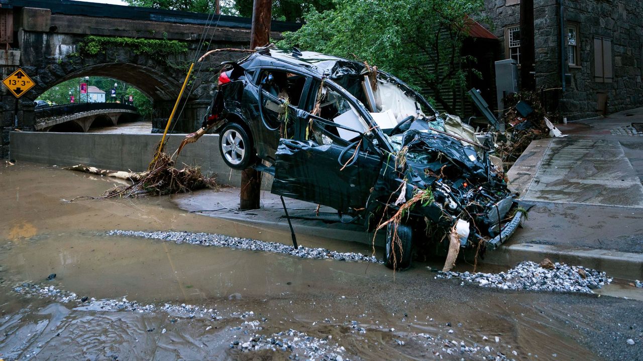 Photo above: A car is damaged on Ellicott City's Main Street.