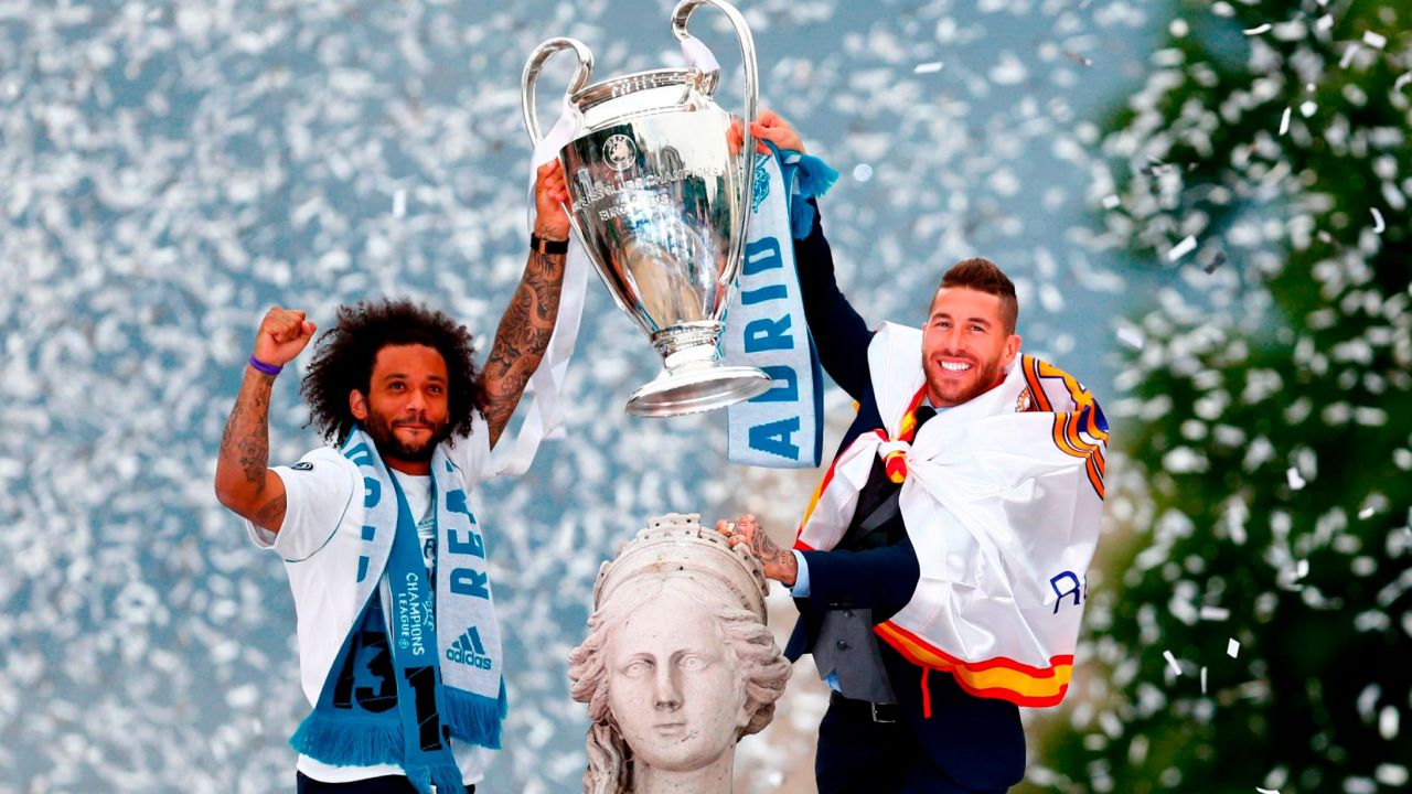 Marcelo and Sergio Ramos hold the Champions League trophy at Cibeles square in Madrid.