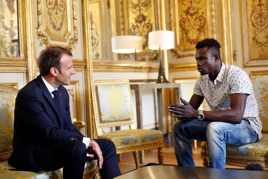 French President Emmanuel Macron (L) speaks with Mamoudou Gassama, 22, from Mali, at the presidential Élysée Palace in Paris, on May 28.