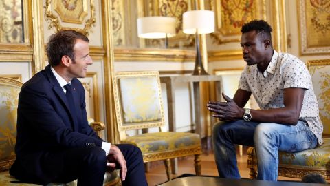 French President Emmanuel Macron (L) speaks with Mamoudou Gassama, 22, from Mali, at the presidential Élysée Palace in Paris, on May 28.
