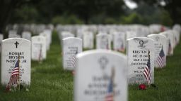 WASHINGTON, DC - MAY 27: Headstones are adorned with flags at Arlington National Cemetery on Memorial Day, May 27, 2018 in Arlington, Virginia. Mourners from throughout the United States travel to Arlington to visit their loved ones on Memorial Day. (Photo by Aaron P. Bernstein/Getty Images)