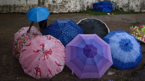 A boy displays umbrellas for sale in Kerala in Southern India, where the annual monsoon has arrived. While the monsoon hasn't yet made it to the northern part of the country, thunderstorms and lightning strikes there have killed 48 people in the past two days.