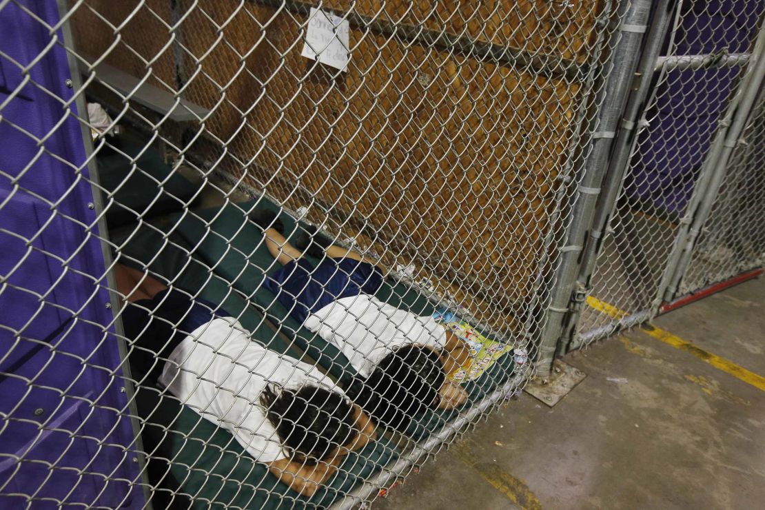 Two female detainees sleep in a holding cell at a US Customs and Border Protection center in Nogales, Arizona, on June 18, 2014.  