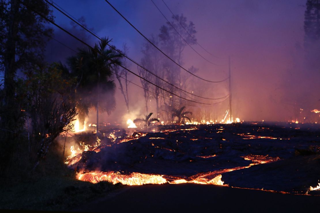 Lava from a Kilauea volcano fissure moves up a residential street in Leilani Estates.