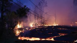 PAHOA, HI - MAY 27:  Lava from a Kilauea volcano fissure advances up a residential street in Leilani Estates, on Hawaii's Big Island, on May 27, 2018 in Pahoa, Hawaii. Lava also flowed to a geothermal power plant today raising fears that toxic gas could be released if wells are breached by lava. The Big Island, one of eight main islands that make up Hawaii state, is struggling with tourist bookings following the Kilauea volcano eruptions, with summer bookings at the island down 50 percent. Officials stress that the eruptions have thus far only affected a small portion of the island.  (Photo by Mario Tama/Getty Images)