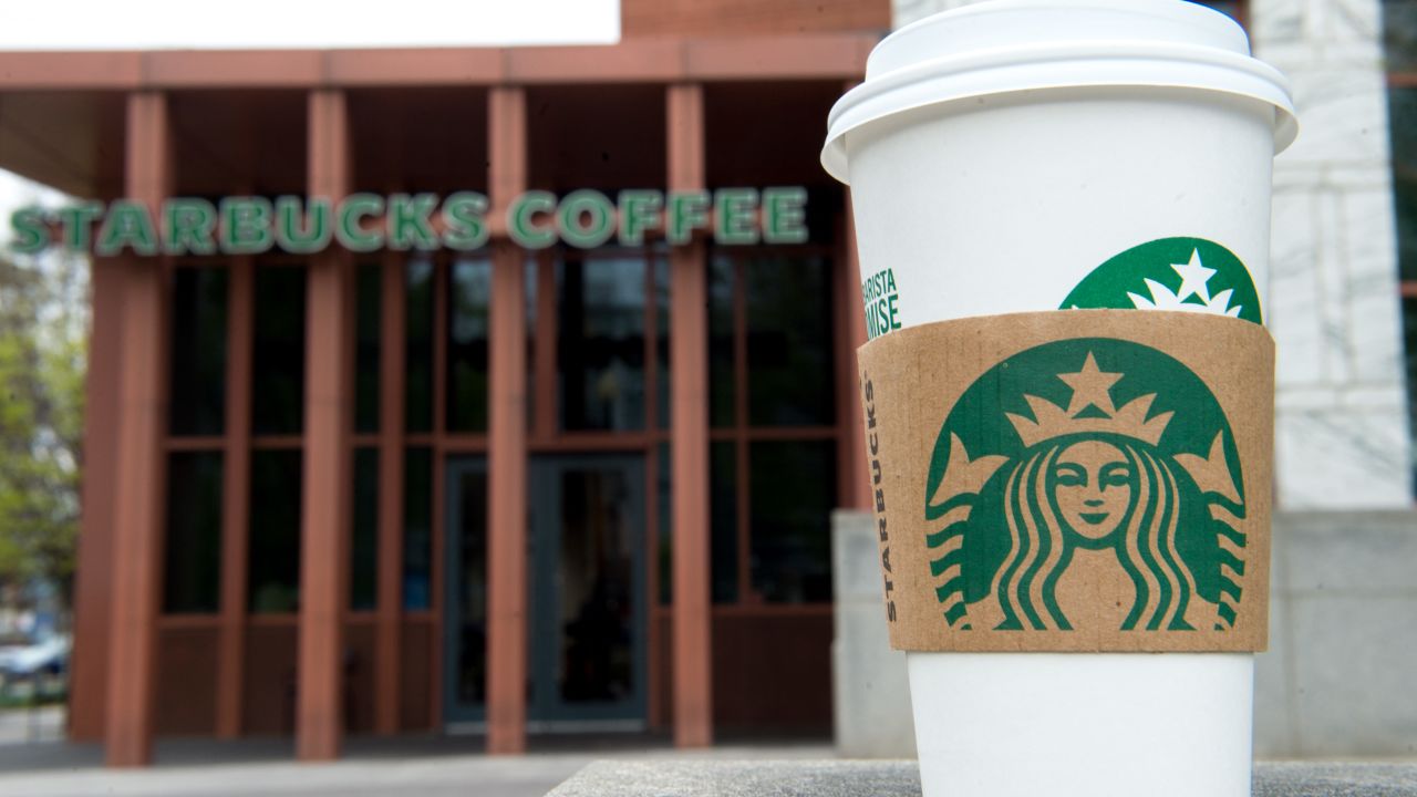 A Starbucks coffee cup is seen outside a Starbucks Coffee shop in Washington, DC, April 17, 2018, following the company's announcement that they will close more than 8,000 US stores on May 29 to conduct "racial-bias education" following the arrest of two black men in one of its cafes. / AFP PHOTO / SAUL LOEB        (Photo credit should read SAUL LOEB/AFP/Getty Images)