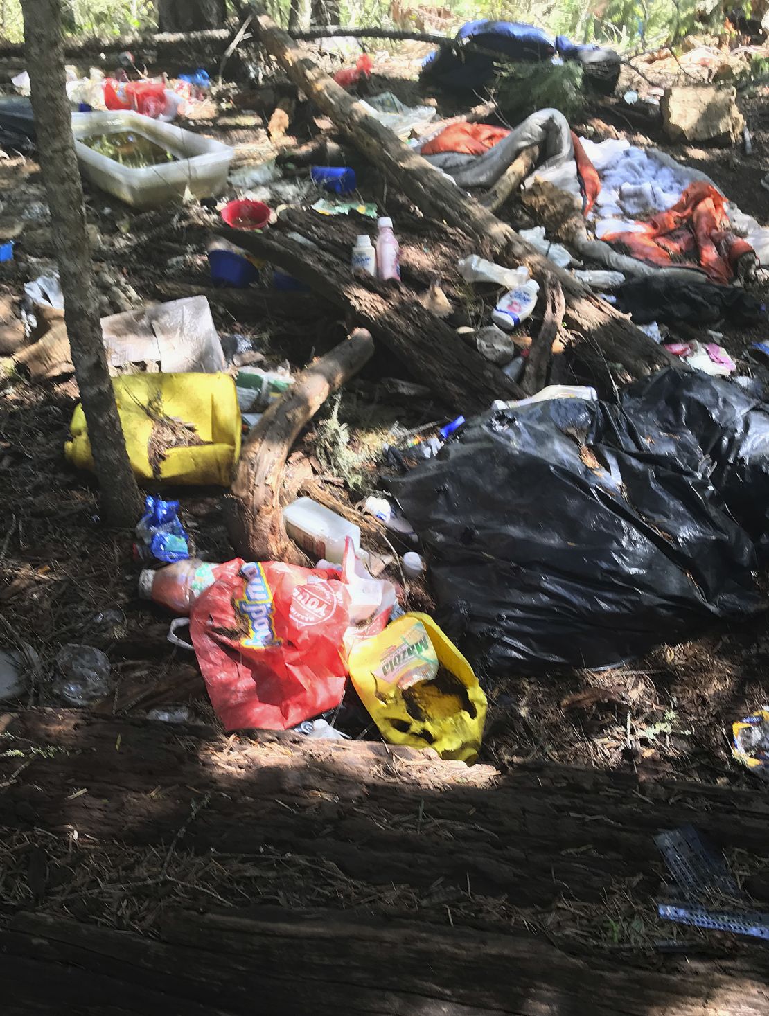 This photo provided by the US Attorney's Office shows trash found at an illegal marijuana site near Hayfork, California.