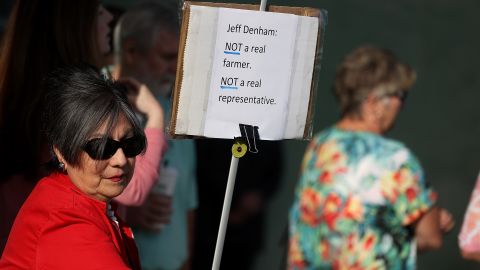 A protester holds a sign outside of a casual "Coffee and Conversation" with U.S. Rep. Jeff Denham (R-CA) at the Riverbank Teen Center on May 9, 2017 in Riverbank, California.