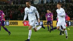Swansea City's Icelandic midfielder Gylfi Sigurdsson celebrates after scoring the opening goal from the penalty spot during the English Premier League football match between Swansea City and Sunderland at The Liberty Stadium in Swansea, south Wales on December 10, 2016. / AFP / Geoff CADDICK / RESTRICTED TO EDITORIAL USE. No use with unauthorized audio, video, data, fixture lists, club/league logos or 'live' services. Online in-match use limited to 75 images, no video emulation. No use in betting, games or single club/league/player publications.  /         (Photo credit should read GEOFF CADDICK/AFP/Getty Images)