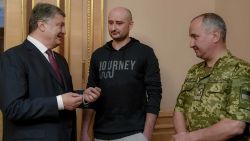 Ukrainian President Petro Poroshenko, left, Russian journalist Arkady Babchenko, center, and Vasily Gritsak, head of the Ukrainian Security Service speak during their meeting in Kiev, Ukraine, Wednesday, May 30, 2018. Babchenko, who was reported shot dead in the Ukrainian capital on Tuesday, showed up at a news conference on Wednesday, saying that the security services faked his death in order to thwart a plot on his life. (Mykola Lazarenko/Presidential Press Service Pool Photo via AP)