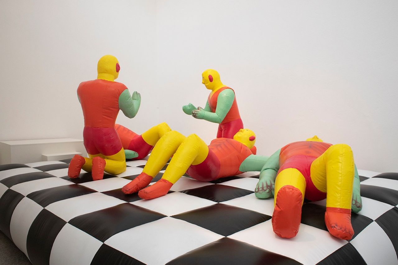 The Dutch Pavilion's "Work, Body, Leisure" exhibition appears to be a plain orange locker room, but surprises -- like this set of inflatable humanoids -- await behind its doors. 