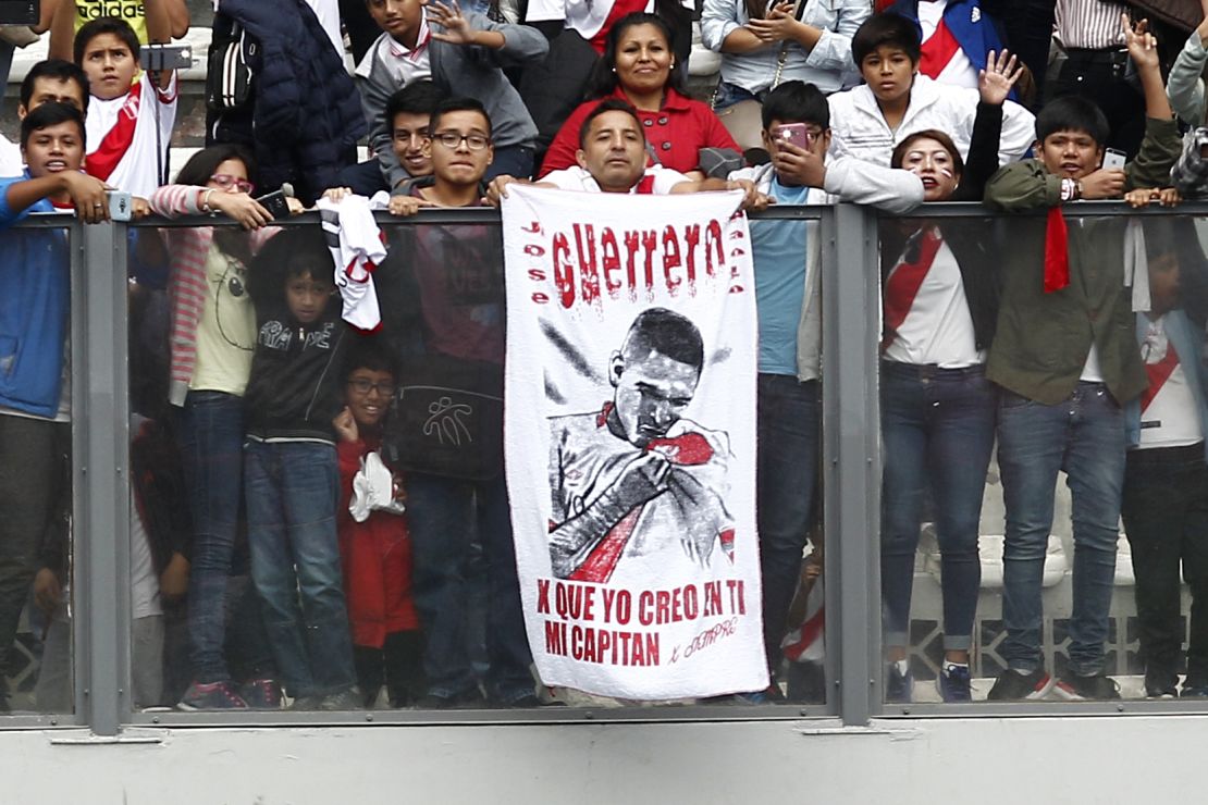 Fans of Peru display a banner in support of Paolo Guerrero.