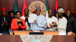 Members of the NotTooYoungToRun movement with Nigeria's President Muhammadu Buhari after he signed the #NotTooYoungToRun bill into law at the Presidential Villa in Abuja, Nigeria's capital city on May 31, 2018.