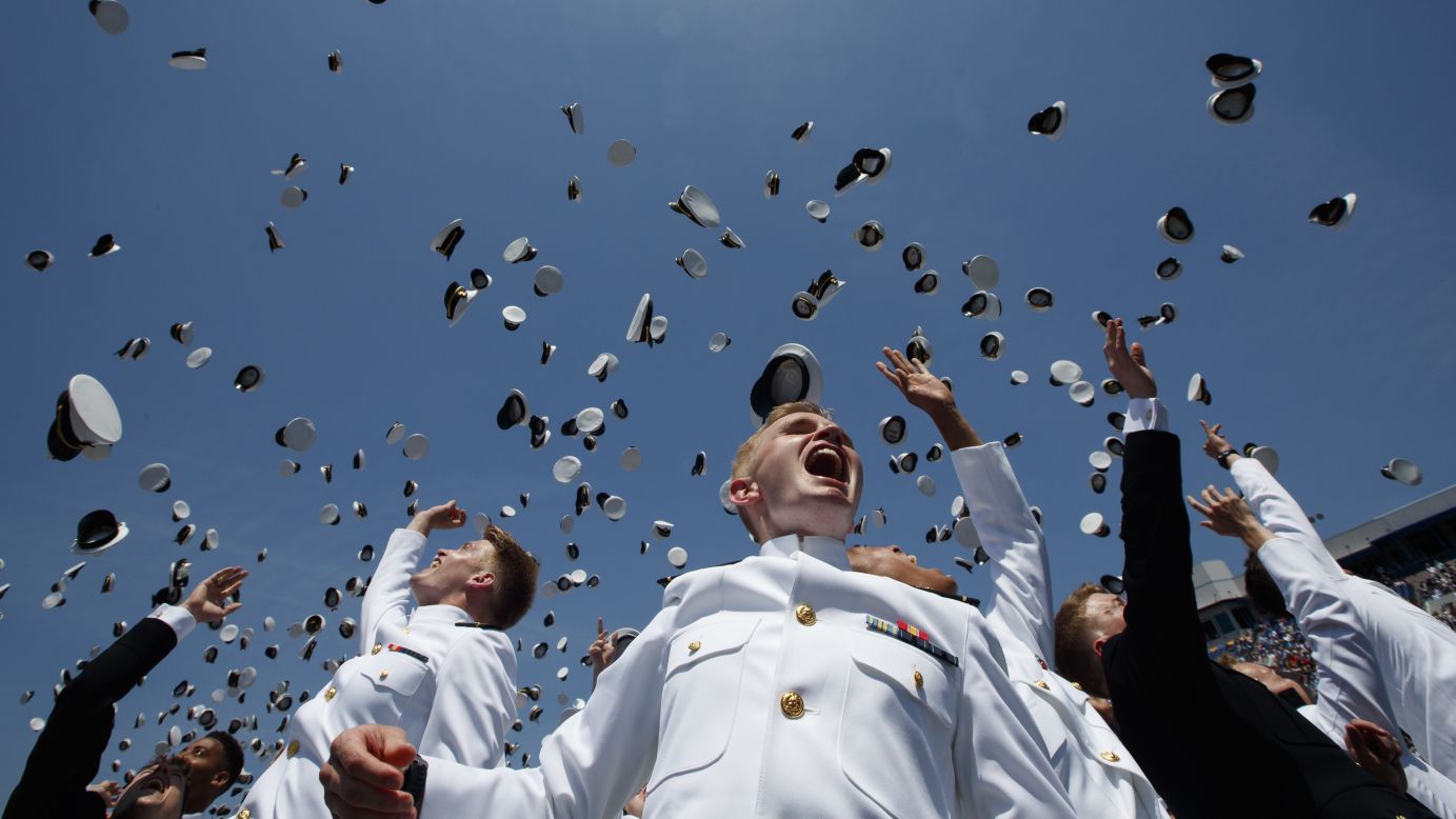 Midshipmen from the US Naval Academy throw their hats into the air during their graduation ceremony in Annapolis, Maryland, on Friday, May 25.