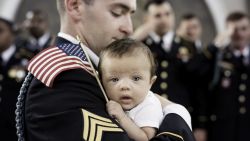 Baby Christian waves an American flag in honor of her father's service.