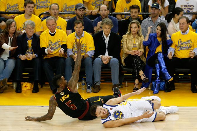 Klay Thompson grimaces in pain after Smith fell into his knee during the first quarter of Game 1. Thompson left the game briefly but returned.