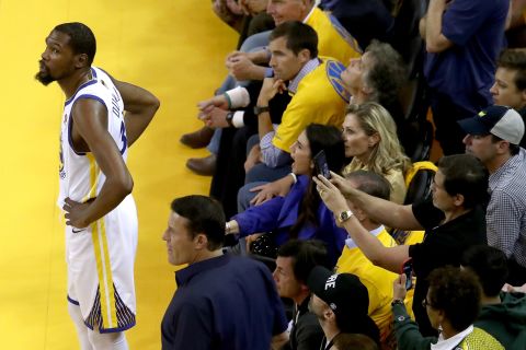 A fan gets a photo of Durant during a stoppage in play.
