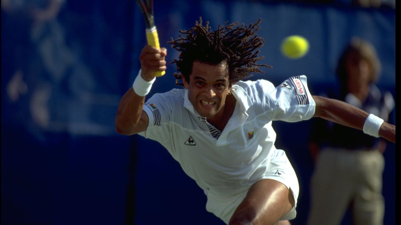 SEP 1989:  YANNICK NOAH OF FRANCE PERFORMS A RUNNING FOREHAND DURING A MATCH AT THE 1989 US OPEN PLAYED AT FLUSHING MEADOWS IN NEW YORK.