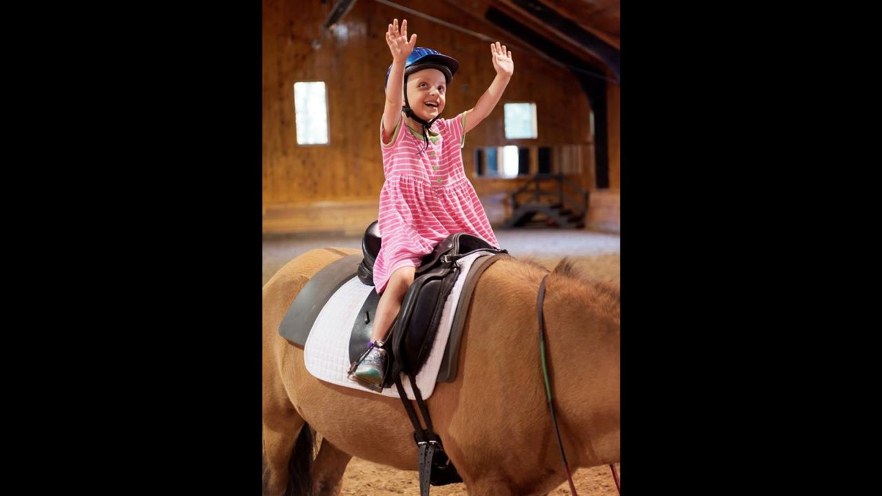Seven-year-old Belle Swersey on her first day of riding lessons at Friends for Tomorrow in Lincoln, Massachusetts.