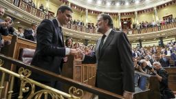 Mariano Rajoy, outgoing Prime Minister  of Spain, right, shakes the hand of Pedro Sanchez, leader of the Spanish Socialist Party (PSOE), following a no-confidence motion vote at parliament in Madrid, Spain, on Friday, June 1, 2018. Rajoy's resistance was finally broken Thursday, overwhelmed by the drumbeat of corruption revelations that has grown throughout his seven years in office. Photographer: Uly Martin/Pool via Bloomberg