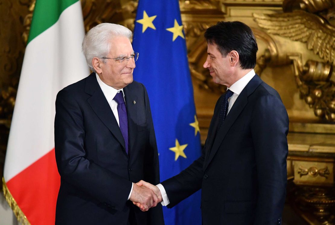 Prime Minister Giuseppe Conte (R) shakes hands with Italy's President Sergio Mattarella during the swearing in ceremony Friday.