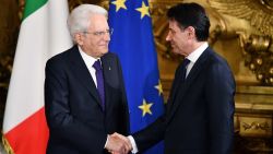 Italys Prime Minister Giuseppe Conte (R) shakes hands with Italy's President Sergio Mattarella during the swearing in ceremony of the new government led by the newly-appointed PM at Quirinale Palace in Rome on June 1, 2018. - Italian cabinet members of the new government led by newly appointed Prime Minister are to be sworn in later in the day, after a last-ditch coalition deal was hammered out to end months of political deadlock, narrowly avoiding snap elections in the eurozone's third largest economy. (Photo by Alberto PIZZOLI / AFP)        (Photo credit should read ALBERTO PIZZOLI/AFP/Getty Images)