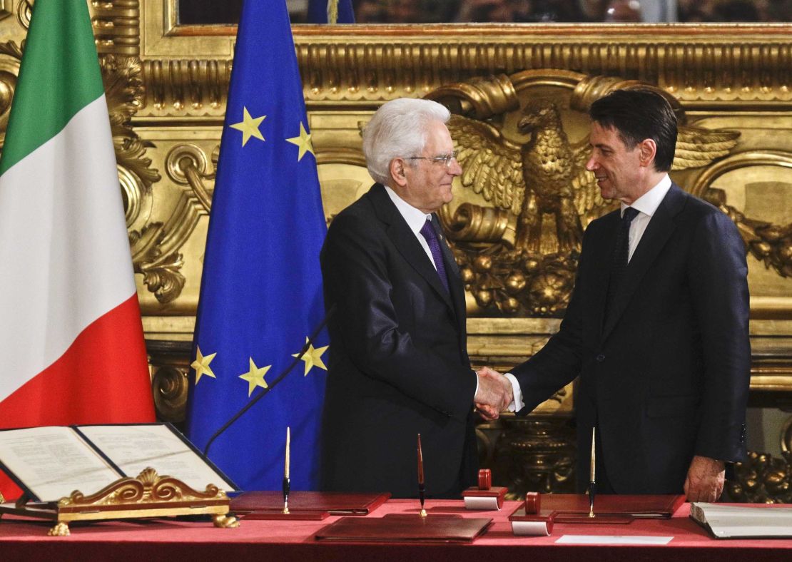 Mattarella (L) shakes hands with Conte during the swearing-in ceremony for Italy's new government Friday.