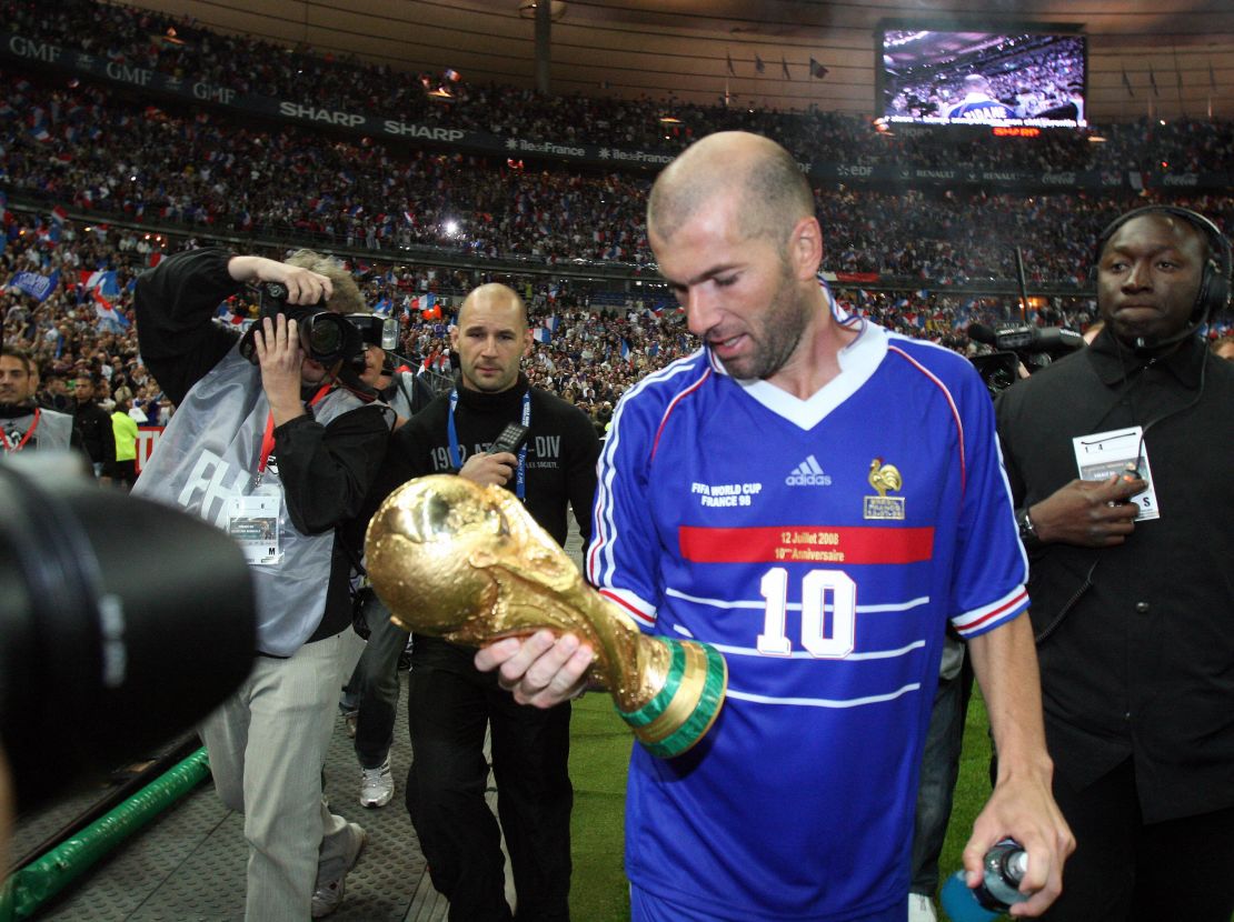 Zinedine Zidane celebrates with the World Cup trophy.