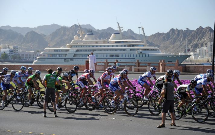Cyclists ride past the Sultan of Oman's yacht Al Said during the Tour of Oman race in 2011. The superyacht reportedly has space for <a href="index.php?page=&url=http%3A%2F%2Fuk.businessinsider.com%2Fexpensive-luxury-yachts-2018-3%2F%23300-million-the-sultan-of-oman-owns-the-509-foot-long-al-said-yacht-it-has-room-for-more-than-60-guests-and-a-concert-hall-that-can-house-a-50-piece-orchestra-6" target="_blank" target="_blank">a concert hall equipped for a 60-piece orchestra. </a>