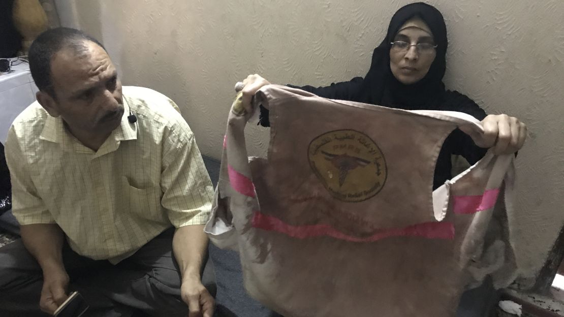 Ashraf and Sabreen al-Najjar display their daughter's bloodied medical vest.