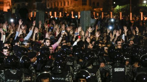 Jordanian protesters raise their hands during a demonstration outside the Prime Minister's office.