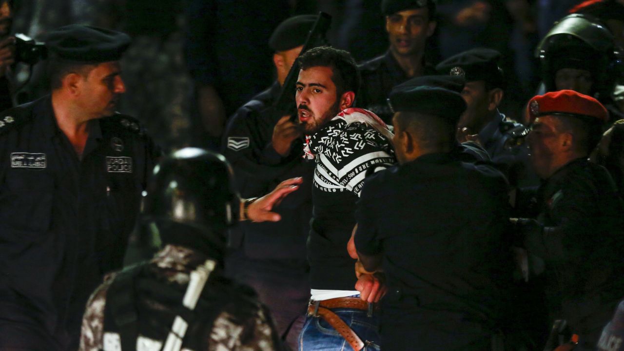 Members of the Jordanian gendarmerie detain a protester on June 2. 
