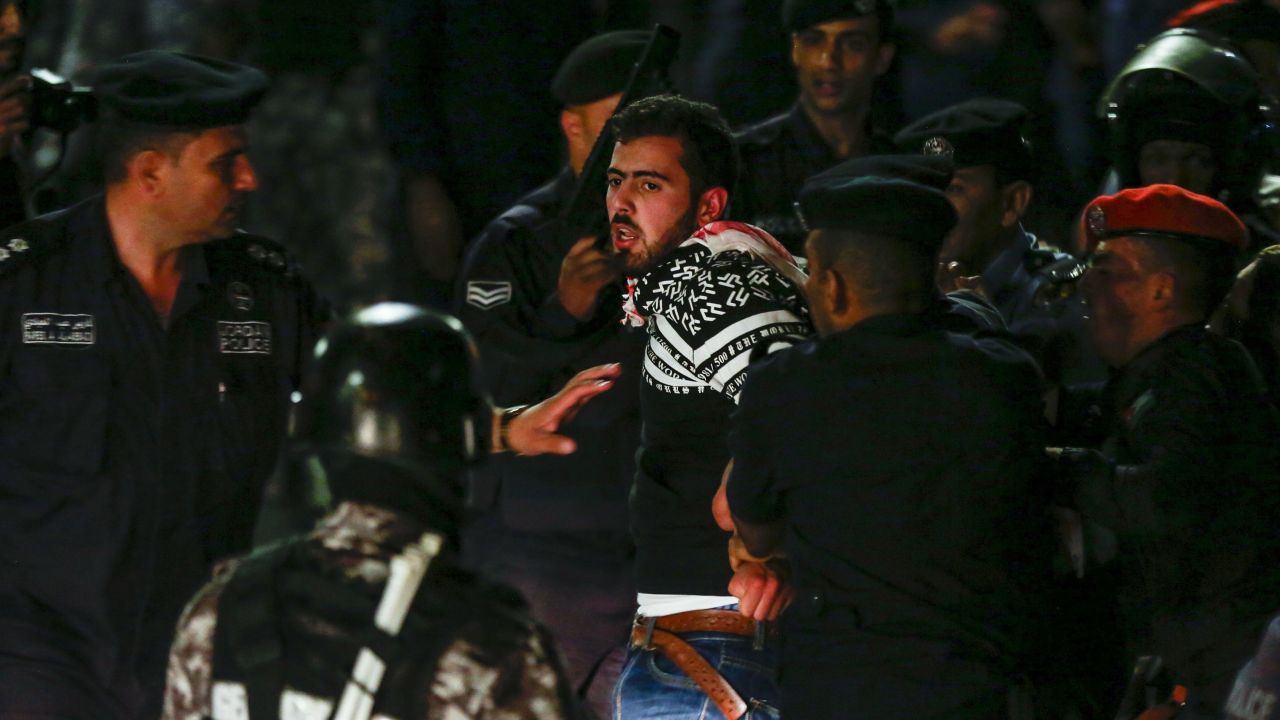 Members of the Jordanian gendarmerie detain a protester on June 2.
