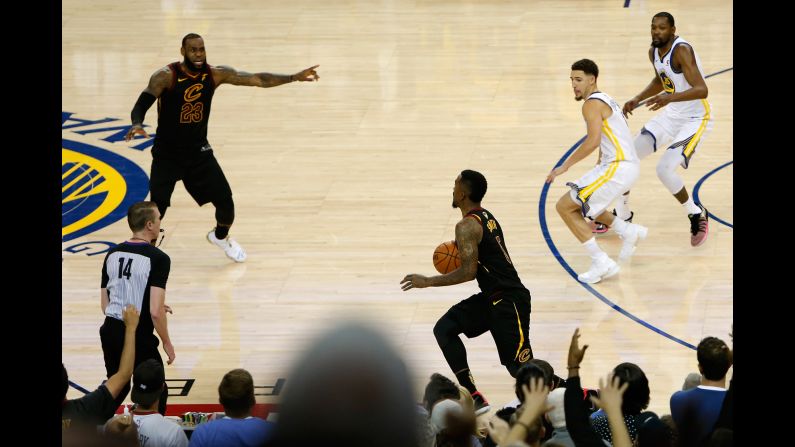 JR Smith (5) of the Cleveland Cavaliers dribbles in the closing seconds of regulation as LeBron James (23) attempts to direct the offense against the Golden State Warriors<a href="index.php?page=&url=https%3A%2F%2Fbleacherreport.com%2Farticles%2F2779161-jr-smith-on-forgetting-score-in-game-1-cant-say-i-was-sure-of-anything" target="_blank" target="_blank"> in Game 1 of the 2018 NBA Finals</a> on Thursday, May 31, in Oakland, California. 
