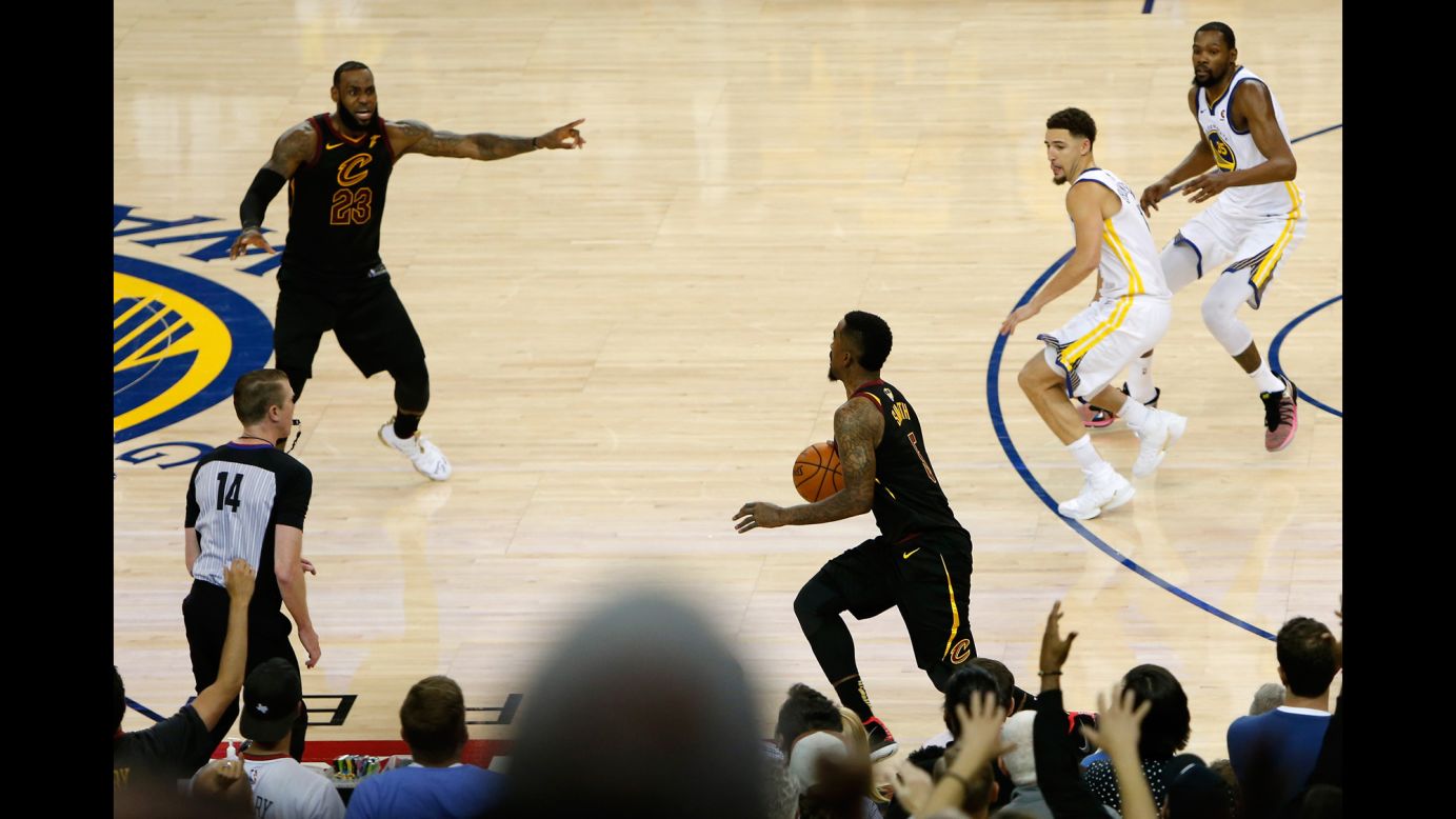 JR Smith (5) of the Cleveland Cavaliers dribbles in the closing seconds of regulation as LeBron James (23) attempts to direct the offense against the Golden State Warriors<a href="https://bleacherreport.com/articles/2779161-jr-smith-on-forgetting-score-in-game-1-cant-say-i-was-sure-of-anything" target="_blank" target="_blank"> in Game 1 of the 2018 NBA Finals</a> on Thursday, May 31, in Oakland, California. 