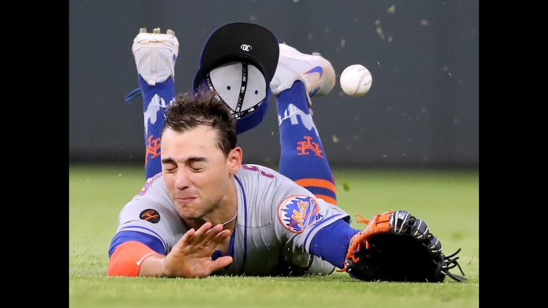 New York Mets centerfielder Michael Conforto can't get to a single by the Atlanta Braves' Dansby Swanson during the eighth inning on Tuesday, May 29, in Atlanta. The Braves won, 7-6.